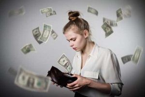 Woman holding a wallet with money